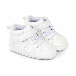 Side view detail of white baby high-top walking shoes with purple elastic laces and velcro