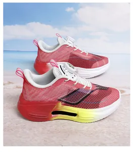 Breathable red mesh running shoes with vibrant gradient soles on a beach background