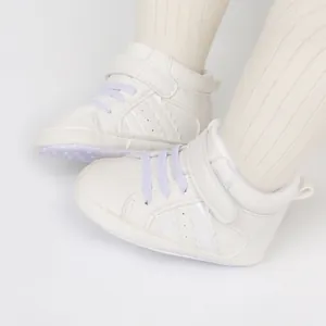 Close-up of white baby high-top walking shoes with soft soles and purple laces