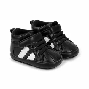 Detailed close-up of black high-top baby walking shoes with soft soles and velcro