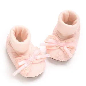 Detailed view of pink lace baby girl socks with elegant ribbon bow for newborns