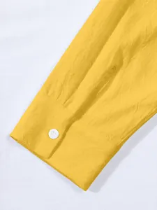 Detail shot showing the cuff and fabric texture of this yellow cotton linen shirt