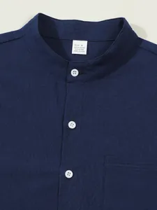 Detailed view of navy blue stand collar shirt with white buttons and linen texture