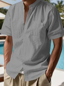 Close-up of a gray linen shirt's henley collar and chest pocket on a male model.