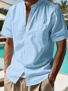 Detail view of light blue linen-textured short sleeve shirt with a stand collar design