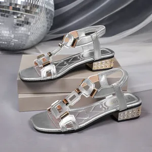Close-up detailed view of silver Roman style sandals with elegant rhinestone block heels
