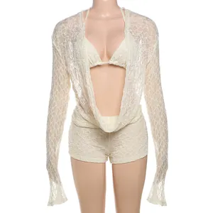 Detailed texture of white lace hollow long sleeve shrug and bikini set