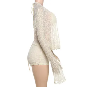 Side view detail of three-piece lace set featuring long sleeves and sheer hollow texture