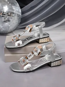 Stylish silver Roman style flat sandals for women with buckle straps and low heel