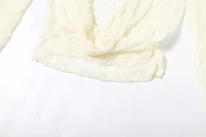 Detailed close-up shot showing the delicate cream white lace hollow long sleeve top texture