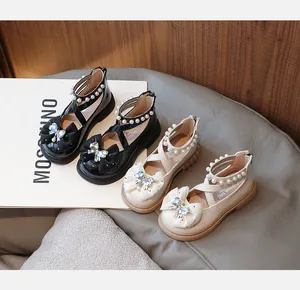 Detailed view of elegant autumn girls' princess shoes featuring pearls and bow accents