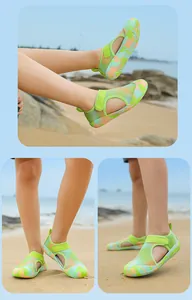 Detailed views of breathable green mesh children's water shoes on a sunny beach.