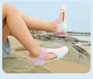 Side view detail of pink mesh children's water shoes with colorful camouflage soles