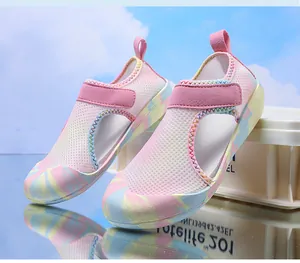 Close-up of pink breathable mesh kids' water shoes with colorful anti-slip rubber soles.