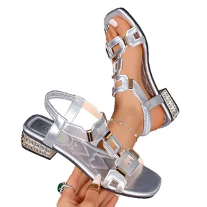Women's silver Roman style flat sandals with metallic buckles and rhinestone heels