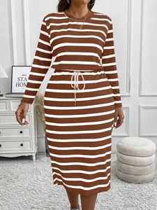Front view of a plus size brown striped dress with drawstring waist on model
