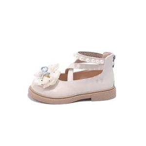 Elegant beige girls' princess shoes with bow detail and pearl-decorated cross straps