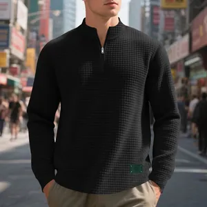 Close-up detail of black waffle texture and half-zipper on casual men's sweatshirt