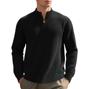 Detailed view of black jacquard waffle texture on men's half-zip stand collar sweatshirt