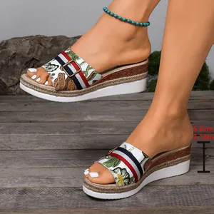 Detailed macro view of women's floral wedge sandals featuring a 5.5cm platform heel