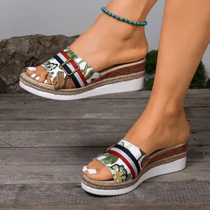 Detailed look at women's floral wedge platform slippers with striped accent straps