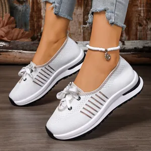 Close-up of white breathable knitted walking shoes for women with lightweight slip-on design