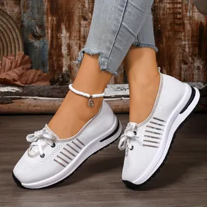 Side view of breathable white mesh slip-on walking shoes with brown striped accents