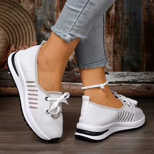 Detailed view of breathable white fly-knit walking shoes for women with slip-on design