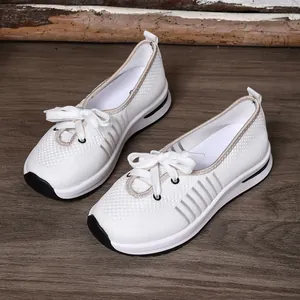 Detail view of breathable white mesh flying weave slip-on walking shoes for women