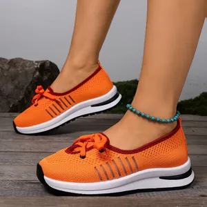 Detail view of breathable orange flying-knit slip-on walking shoes for active women