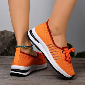 Close-up of orange mesh walking shoes showing breathable knit texture