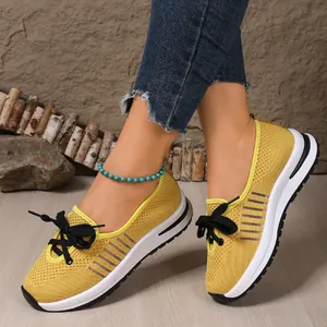 Detailed view of yellow breathable mesh fly-knit slip-on sneakers for women