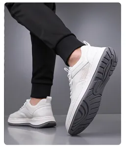 Detailed view of men's white breathable fly-knit mesh sneakers with non-slip soft grey soles