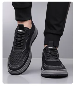 Close-up of black breathable mesh sneakers with grey non-slip soles on a male model