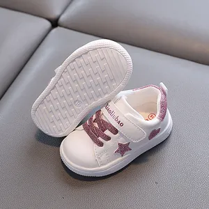 White toddler sneakers featuring pink glitter star and heart designs on non-slip rubber soles