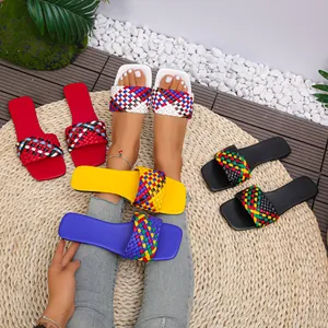 Detailed view of colorful woven square-toe flat slides in multiple vibrant shades
