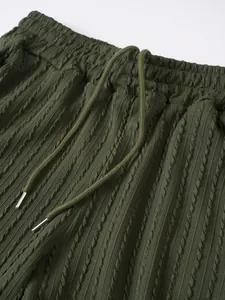 Detailaufnahme einer olivgrünen Herren-Sportshorts mit Kordelzug und strukturierter Optik.