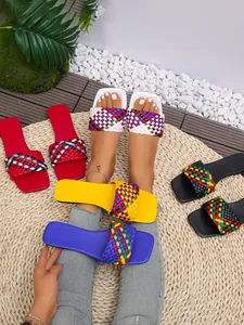 Close-up of vibrant multi-colored woven flat sandals with square toe design