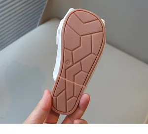 Detailed macro view showing the non-slip geometric pattern and size on girls' sandal sole
