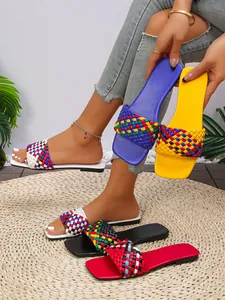 Detailed close-up of vibrant multi-color woven strap flat sandals with a square toe design.