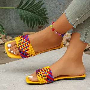 Detailed view of women's colorful woven flat sandals with a stylish square toe design