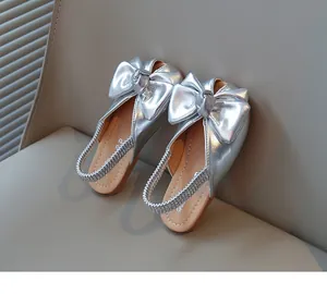 Detailed view of silver metallic girls' sandals featuring large decorative bows