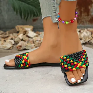 Detailed view of colorful woven strap on black square toe flat slides for women shoes