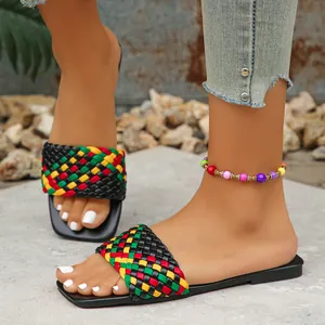 Close-up view of colorful woven flat slides with square toe design and street style fashion