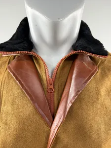 Close-up detail of vintage Michigan work jacket featuring black fur collar and zipper closure