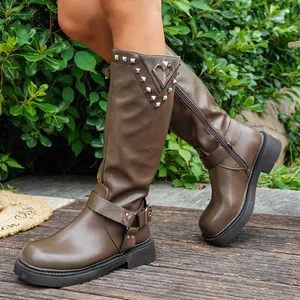 Detailansicht brauner mittelhoher Stiefel mit Nieten und einer herzförmigen Schnalle