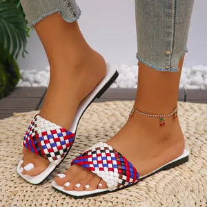 Close-up of stylish multi-color braided flat sandals with a modern square toe design.