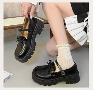 Close-up of black retro platform Mary Jane shoes with bow detail and thick lug sole for JK style