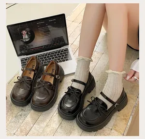 Close-up of retro British style platform Mary Jane shoes in black and brown finishes.