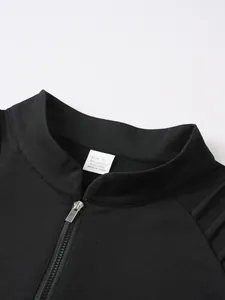 Close-up detail of black sports sweatshirt with zipper stand collar and fabric care label